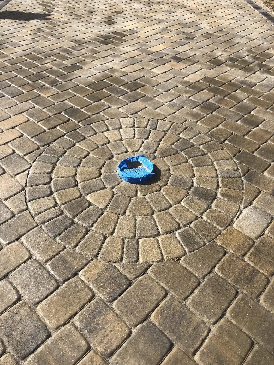 Cobblestone circle detail set into a paver patio